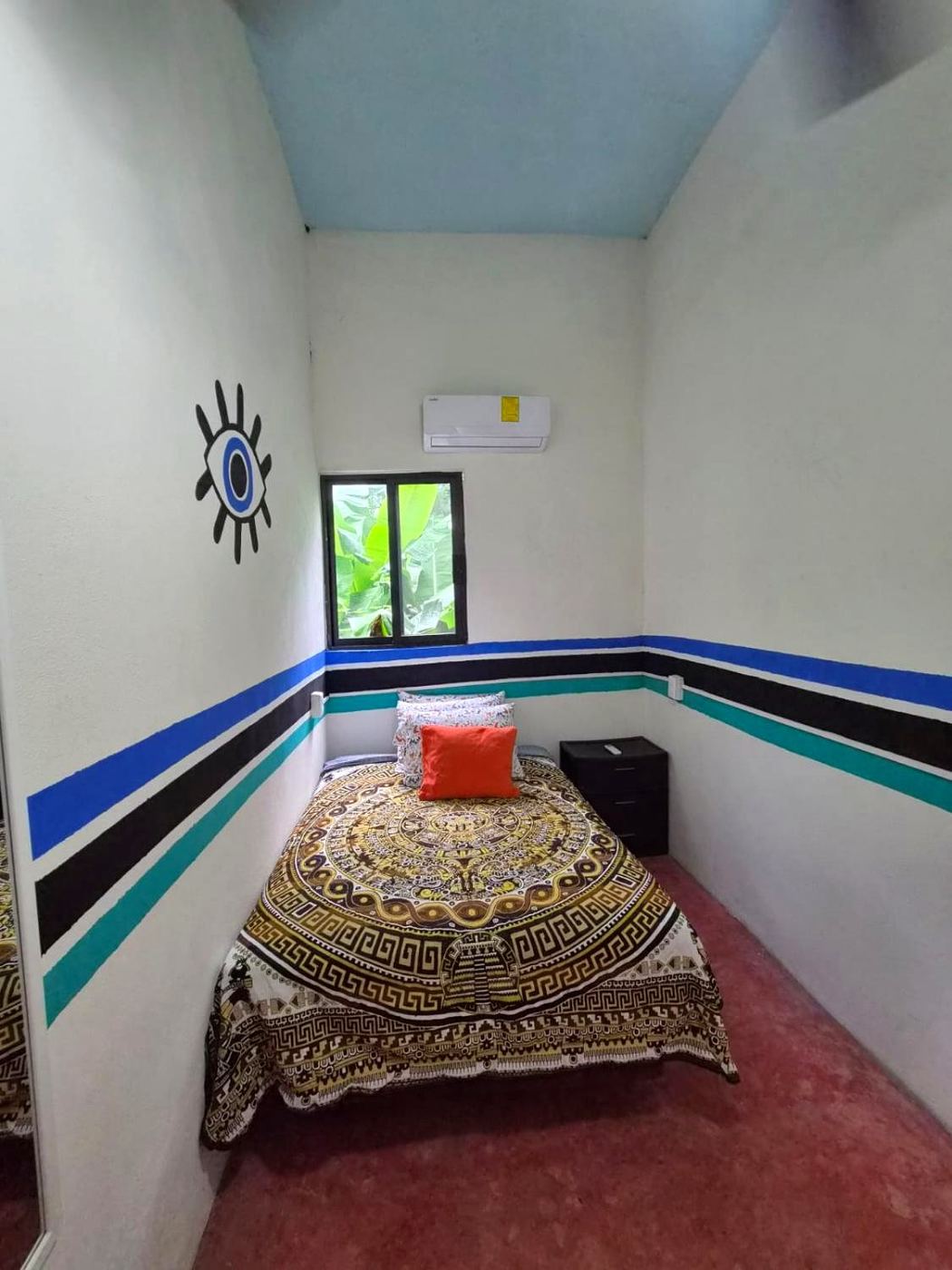 The eye bedroom at Two bedroom Delight, blue ceiling and stripes of blue, black, and teal