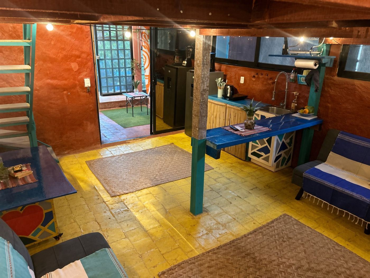 Yellow tile at El Loft, the blue bar, and the garden just past the open door